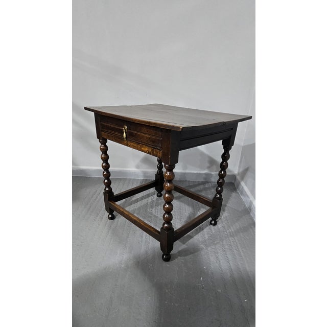 Very good 17th century oak sidetable with stretchers and bobbin turned legs, single full width drawer with brass dropper...