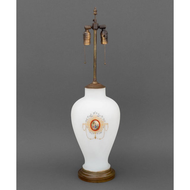 French Style Milk Glass Vase Mounted as a Table Lamp, with center painted medallion with two women amongst a landscape...