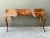 Fashioned with elegant Italian curves and book-matched olive burl wood veneers, this vintage writing desk features a...