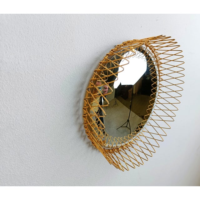 Metal sunburst mirror with convex mirror glass. The golden mirror is in a very good condition. The brass frame is...