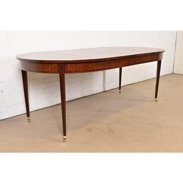 An exceptional Federal, Hepplewhite, or Regency style extension dining table By Henredon USA, Circa 1960s Gorgeous banded...