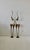 A pair of tall, stylized bronze-toned metal gazelle sculptures with slender legs and elegant curved horns. Individually...
