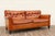Wonderful vintage American-made leather sofa from the 1970s. Upholstered in a rich honey brown leather that has developed...