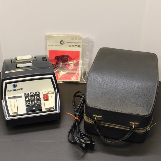 Vintage retro Commodore desktop calculator featuring the iconic Commodore logo, classic angular gray casing, and chunky...