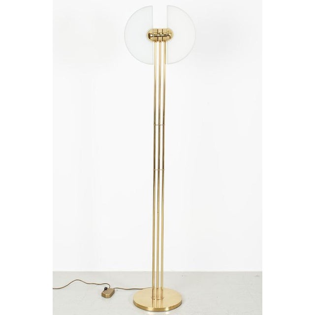Beautiful brass floor lamp. The chic lamp has a striking and elegant design. The lamp has rotating glass shades and...