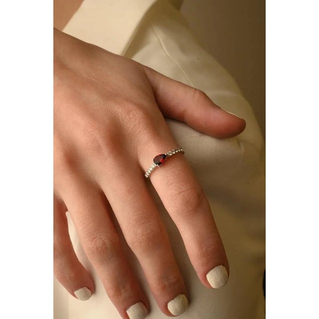 This is part of Chairish’s Fine Jewelry assortment. Garnet Ring with Diamonds featuring natural garnet of 0.45 carats and...