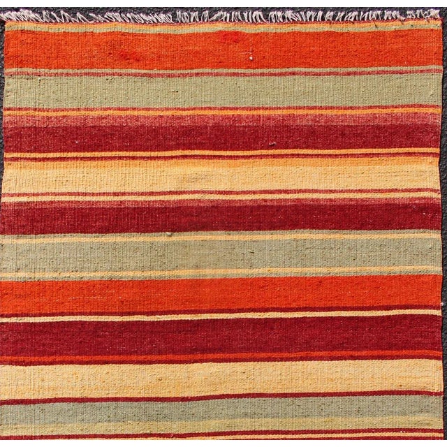 Turkish Kilim runner with stripes in red, green, yellow, orange, rug country of origin / type: Turkey / Kilim, circa...