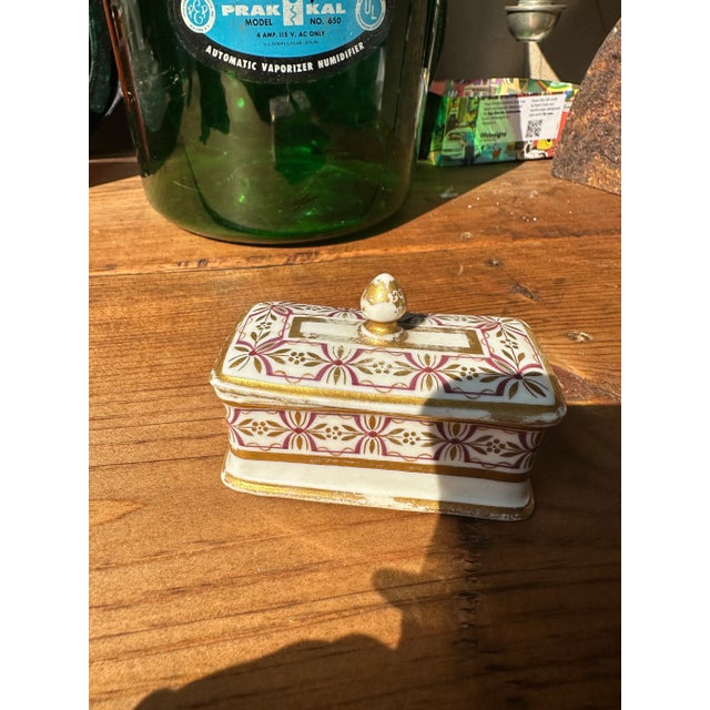 Up for consideration is a beautiful small ceramic catchall with a matching lid and gold accents. This would look lovely in...