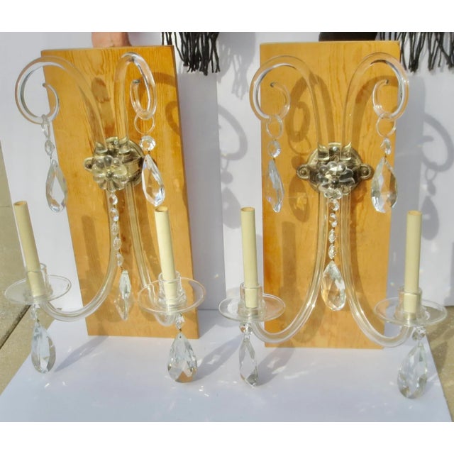Silvered Bronze and Crystal Sconces from the 1920s. Irish crystals with curls and rings swagged from each arm. Two candle...