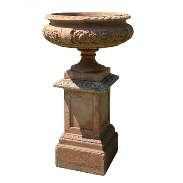 A stunning and substantial two-piece garden set featuring a classic Neoclassical terracotta tazza-form urn resting on a...