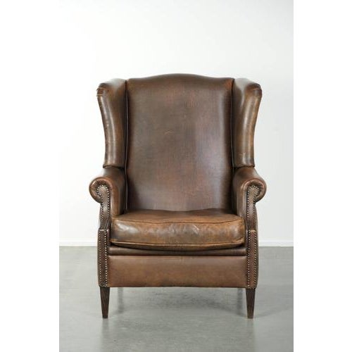 This beautiful large wing armchair with lovely colors is made of sheepskin and looks perfect in both classic and modern...