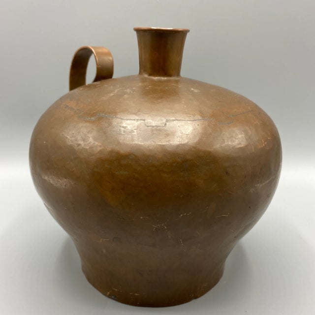 Wonderful craftsmanship in this hand made hammered cramp seamed copper vessel. It has the appearance of a moonshine/water...