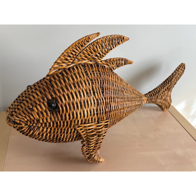 This vintage woven rattan fish is a striking decorative piece with a metal frame for added structure. Measuring...