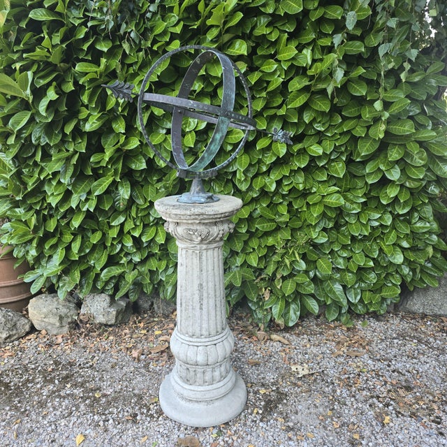 Armillary sundial on a concrete corinthian column base. The dial is made of copper, and has weathered to a lovely verde...