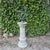 Armillary sundial on a concrete corinthian column base. The dial is made of copper, and has weathered to a lovely verde...
