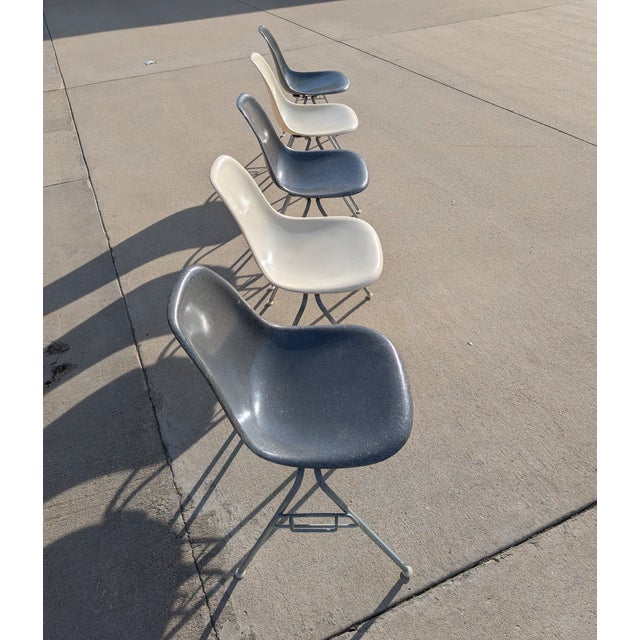 Original set of 5 DSS molded fiberglass shell chairs on stacking base, designed by Charles and Ray Eames for Herman...