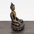 This elegant antique bronze sculpture from India features a seated Buddha with fine details, including a textured hair...
