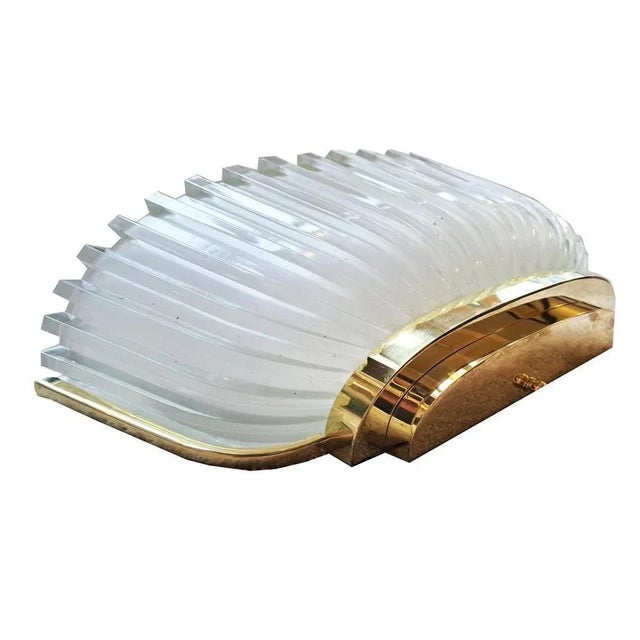 Pair of Art Deco wall lamps France around 1930. Brass and sandblasted glass. Stepped half-shells in brass with inserted...