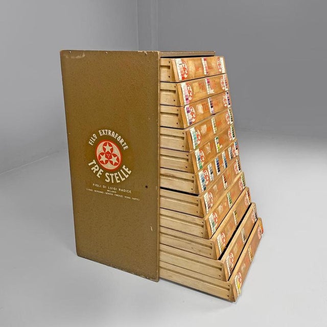 Italian mid-century modern wooden dresser and threads Cucirini Tre Stelle, 1960s Chest of drawers or sewing cabinet with a...