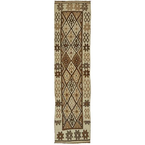 This exquisite runner rug is a rare example of tribal craftsmanship, hand-knotted by the women of the Herki tribe during...