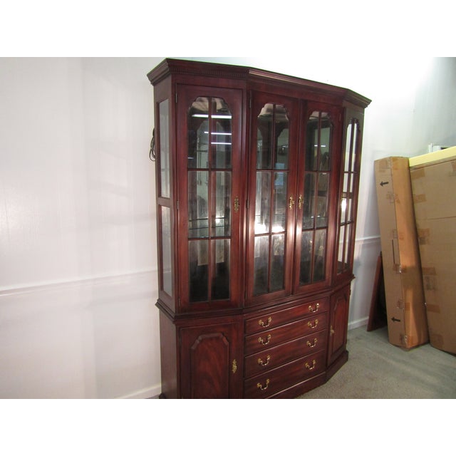 Item 87956: Henkel Harris solid mahogany china cabinet. Age: 1990's. Details: Two piece construction, lighted interior,...