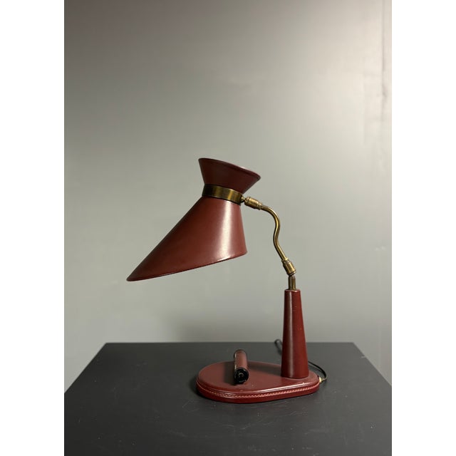 Desk lamp in oxblood leather and brass, france, 1950s, often attributed to jacques adnet. This is the version with the...
