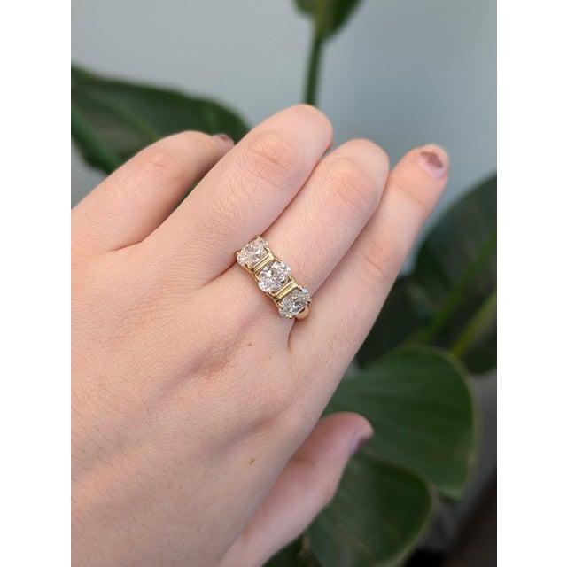 Three oval lab-grown diamonds sit in a row across this solid 14K yellow gold ring, 2.22 carats in all. Grown in a...