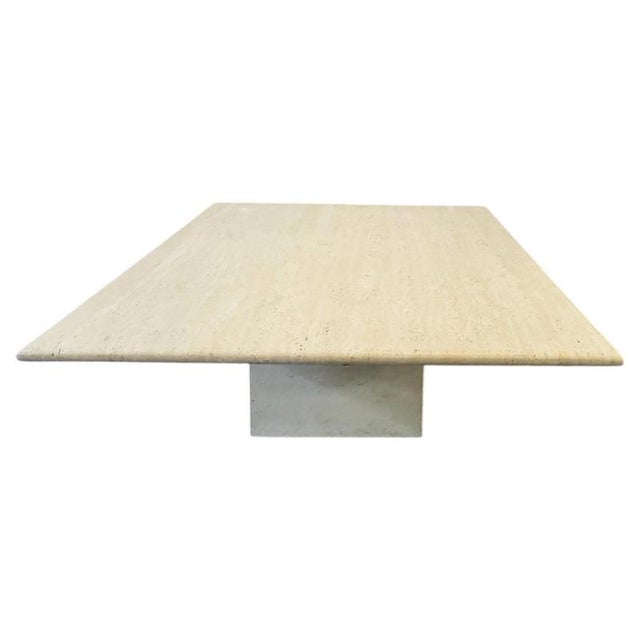 This is an elegant set of two square coffee tables crafted entirely from natural beige Italian travertine. For sale...