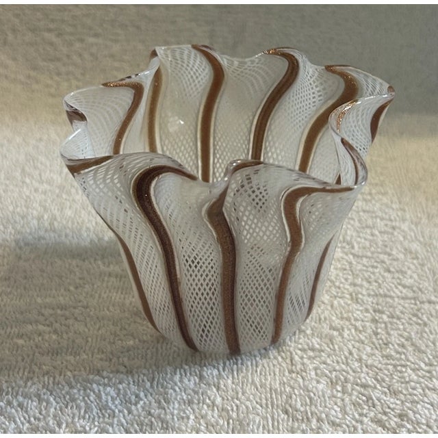 Add a touch of timeless Italian elegance to your collection with this **vintage Murano petite handkerchief vase**,...
