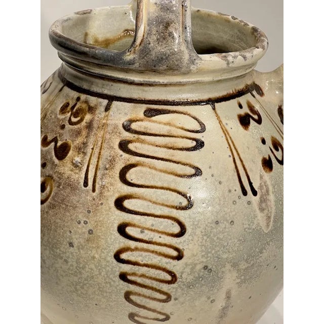 A French olive oil jug, known as a "cruet à huile d'olive" or simply "pot à huile d'olive" in French, is a vessel...