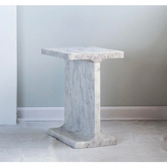 The "I" Beam shaped table is made of solid, carved marble and makes a great base for sculpture, vases or lamps.