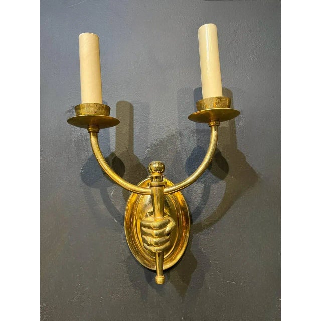 A circa 1930's gilt bronze double lights hand sconces.