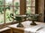 A pair of 19th century French small cast iron garden urn planters with pedestal base and scrolled handles. Weathered green...
