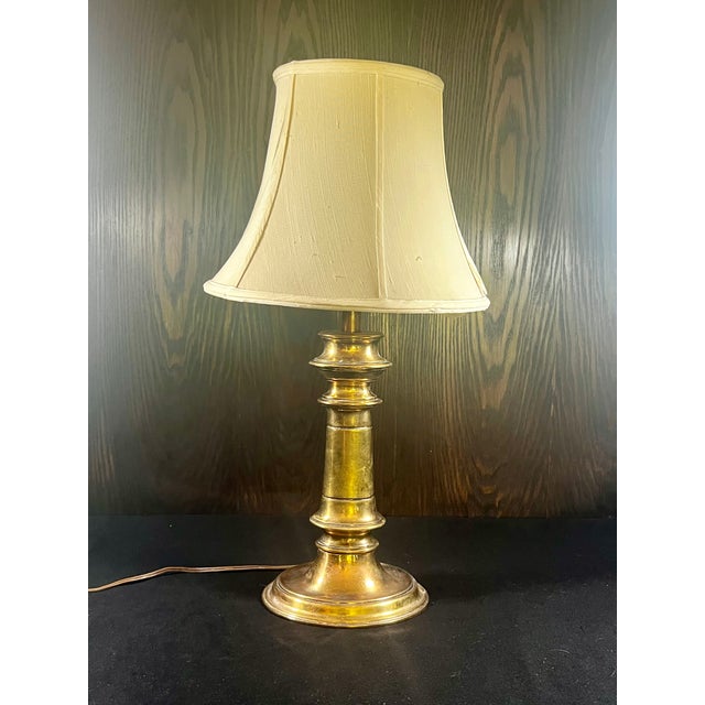 Well-loved vintage brass table lamp Oblong base with elegant scale Lovely patina Turn switch at base Stiffel label on...