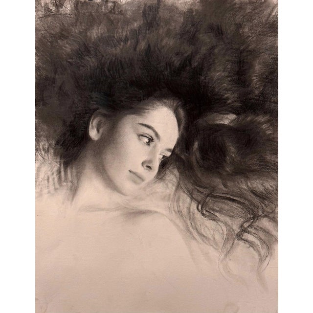 This artwork features a serene portrait of a young woman, her expression contemplative as she gazes off into the distance....