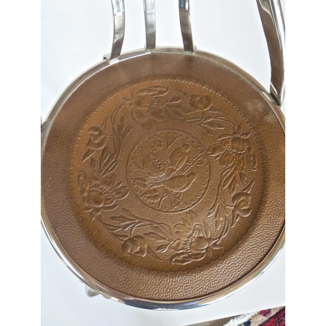 American three-piece ice cream parlor suite, consisting of a table and two chairs. The table has three steel metal legs...