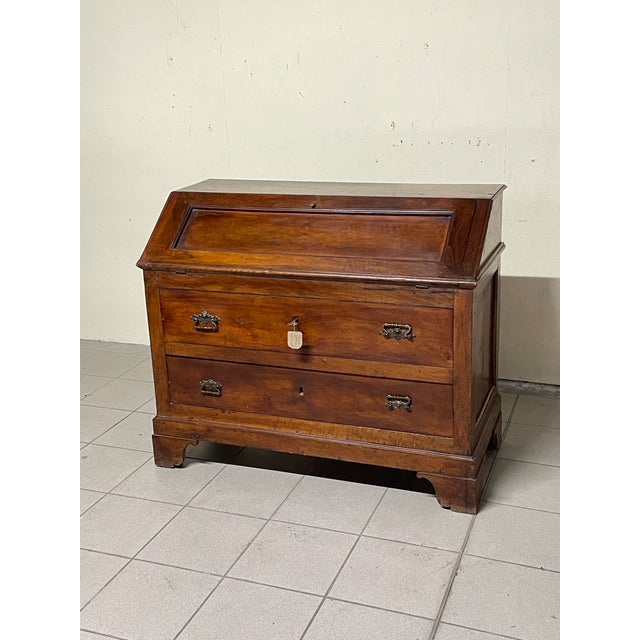An antique 18th-century Italian bureau from Piedmont (northern Italy). Its walnut structure features a "calatoia," the...