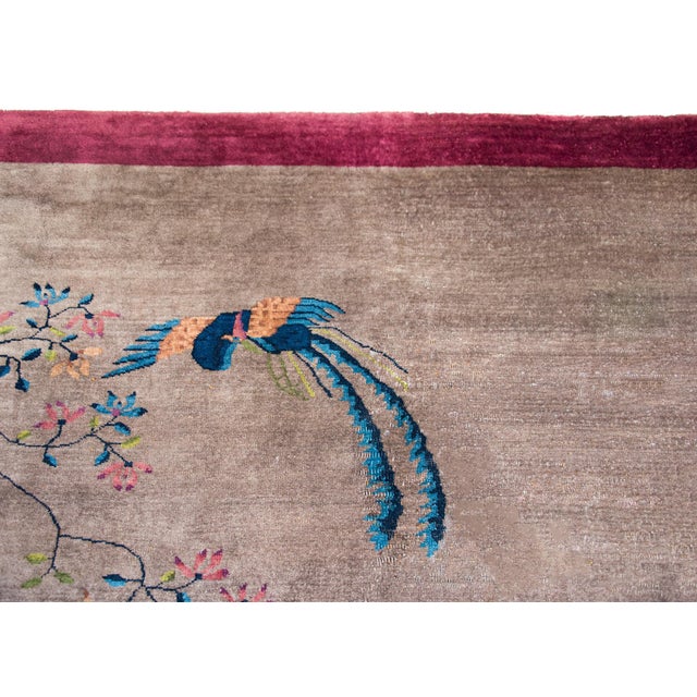 A beautiful early 20th century Chinese Art Deco rug with a gray field surrounded by a wide eggplant colored border, and...