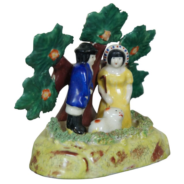 Antique early English Staffordshire porcelain pearlware bocage group, showing male and female shepherds with a red and...