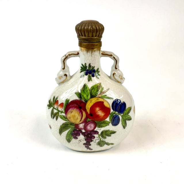 This porcelain bottle is 100% hand painted. The bottle comes with a brass top