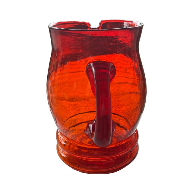 This hand-blown tangerine glass pitcher is a standout example of Art Deco-influenced mid-century barware. It is notably...