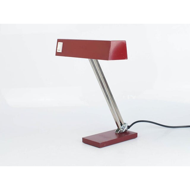 Desk lamp by the German manufacturer Pfäffle from the 1960s. Model 873. Rare version in dark red. Made entirely of metal....