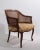 Provincial style tub chair having a carved wood frame, with caned sides and backrest. The chair is in good, original...