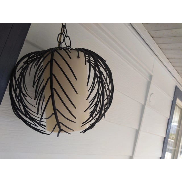 This early 1970's pendant is made of black steel with an acrylic inner shade can be used nicely over a dining table or in...