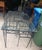 Vintage Outdoor wrought Iron dining set, in black. Unmarked, in the style of Salterini. 4 chairs and one table with glass...