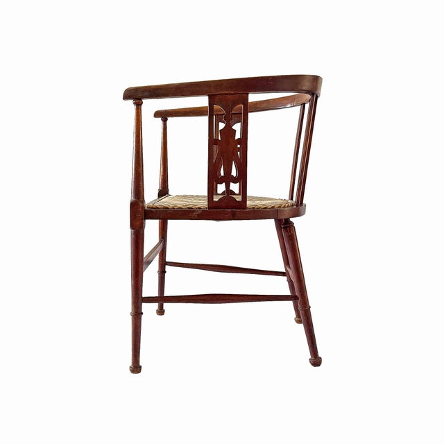 Antique Edwardian stained beech, mahogany and chequer banded tub shaped chair with turned tapering legs. Seat upholstered...