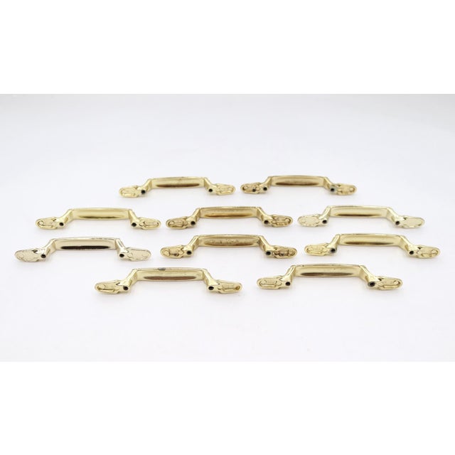 Traditional style newly made polished brass bridge drawer or cabinet pulls. Made by Amerock. Mounting screws are included....