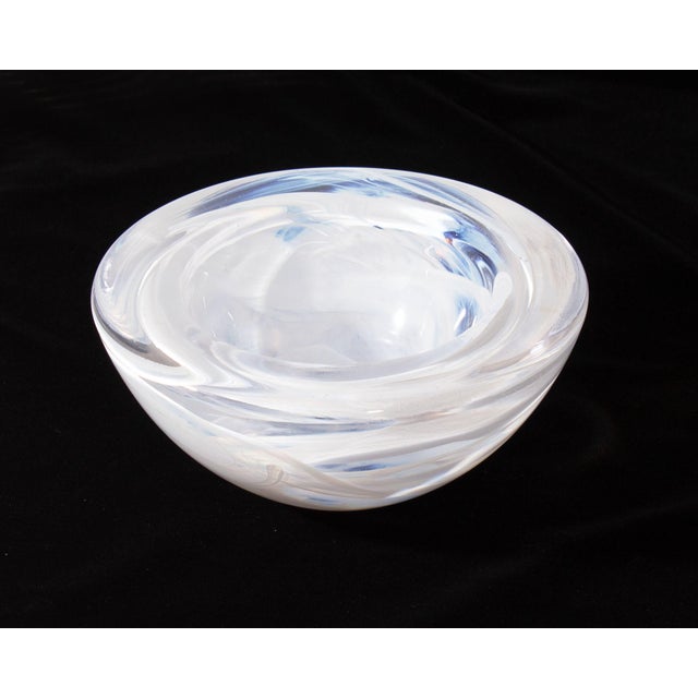 An "Atoll" glass bowl designed by Swedish glass artist Anna Ehrner (born 1948) for Kosta Boda. This bowl is circular with...