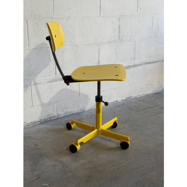 This vibrant yellow office chair brings retro charm to any workspace. Featuring a sturdy metal frame and plywood seat on a...