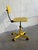 This vibrant yellow office chair brings retro charm to any workspace. Featuring a sturdy metal frame and plywood seat on a...